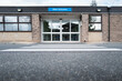 © Nick Beer - Ground level view of a patient zebra crossing leading to the entrance of a typical NHS hospital in Britain. The building is for outpatient care.