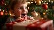 © thanakrit - Excited Little Boy Opening Christmas Present Under Decorated Tree.