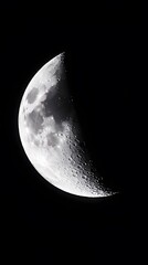 Poster - A crescent moon shines brightly in the dark night sky.