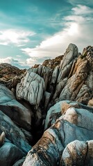 Canvas Print - Close-up view of a rugged rock formation with a bright sky in the background.