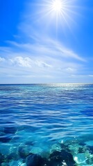 Wall Mural - Clear blue water and sky with the sun shining brightly.