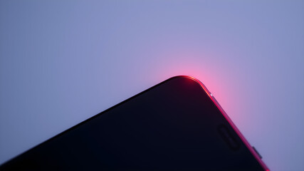 Wall Mural - red light lines on the edge of the phone on a dark background. generative ai