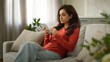 © Yuliia - Shocked upset sad Caucasian troubled woman female girl client holding mobile phone cellphone reading bad news negative reaction no connection smartphone error failure losing online game at home couch