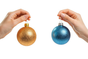 Two  hands gently holding hanging shiny christmas balls, ready to decorate Christmas tree. Isolated.