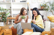 © freebird7977 - Young women and friend help moving home while packing boxes and shopping online for decorating new home.  Asia women happy and together for investment real estate for living with family