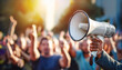 © Bob Orsillo - person with a megaphone speaking to a crowd of people