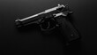 © Sadia - A close-up view of a black pistol resting on a solid dark surface in low light setting