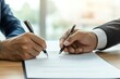 © Steveandfriend - Two professionals signing a contract, showcasing collaboration and agreement in a modern office environment.