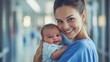© Karina - Caring nurse smiles while holding her happy newborn in a hospital