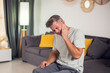 © Aleksej - A man holding his face in pain due to a toothache. His expression reveals his suffering as he tries to alleviate the ache. People and healthcare concept