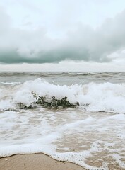 Sticker - White Waves Crashing on Sandy Beach Under Cloudy Sky