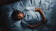 © Nathamanee - A boy is sleeping on a bed with a white sheet