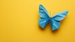 © Jojo - A folded butterfly in bright blue paper, fluttering on a soft yellow background