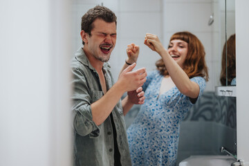 Poster - Joyful young couple laughing together in the bathroom while preparing for an exciting evening out. Captures the essence of fun, friendship, and anticipation.