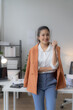 © Tj - portrait of beautiful young Asian business woman standing while smiling looking at camera in the office