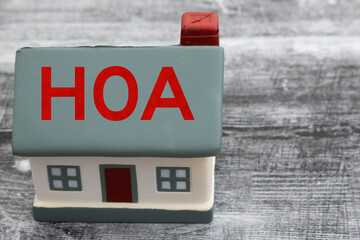 Sticker - Troubled HOA with a house on weathered wood desk