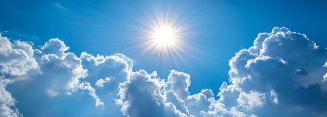 Shining sun through fluffy clouds on blue clean sky background