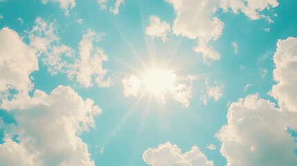 Shining sun through fluffy clouds on blue clean sky background