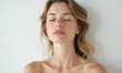 © junet - a beautiful woman with closed eyes, standing in front of a soft white background