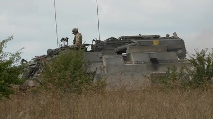 Wall Mural - commander directing a British Army Challenger Armored Repair and Recovery Vehicle (CRARRV) FV4204 in action on a military training exercise