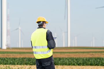 Aufkleber - Engineer with digital tablet works on a field of wind turbines