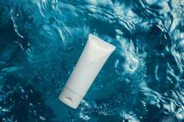 Wall Mural - A white tube with cream lies on the surface of blue water