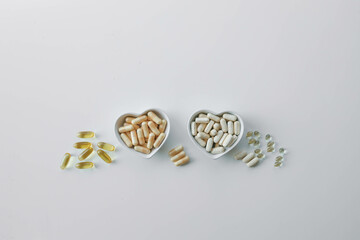 Tablets and vitamins on white background, banner advertising, pharmaceuticals