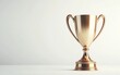 © CHONCHANOK PHOTO - 3D Shiny golden trophy on a soft background, symbolizing achievement and excellence in sports or competition.