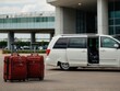 © buena17 - Travel bags and minivan at airport ready for convenient journey departure
