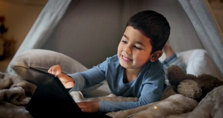 Wall Mural - Tablet, games and a boy in a tent the bedroom of his home for education, learning or child development. Smile, technology and relax with a happy young kid on the floor for fun in an apartment