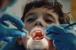 © Alena - A young boy sitting in a dentist's chair having his teeth checked