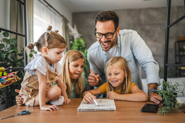 Adult single father of three daughters help them to do homework