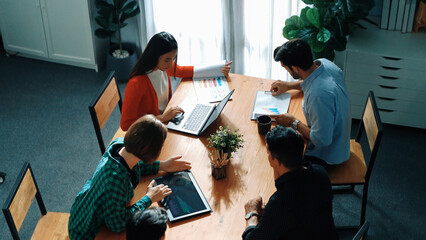 Top view of project manager present financial graph to investors at meeting. Professional marketing team brainstorming financial idea while looking at financial statistic from laptop. Convocation.