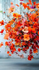 Poster -   Orange and Pink Flowers - Orange and pink flowers hang on a white wall, framing a white background