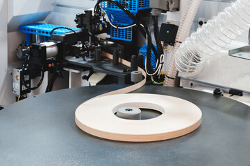 Poster - A machine is cutting a strip of wood. The machine is surrounded by other machines