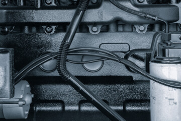 Aufkleber - A close up of a diesel engine with a hose coming out of it. The hose is connected to a container
