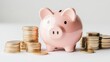 © sanntoru - Pink piggy bank on gold coins, isolated on white background, symbolizing savings and investment