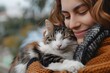 © Valentin - A Heartwarming Moment: Woman Embracing Her Content Cat