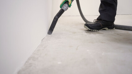 Wall Mural - Construction worker vacuuming concrete floor.