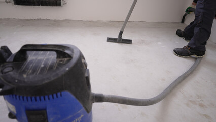 Wall Mural - Construction worker vacuuming concrete floor.