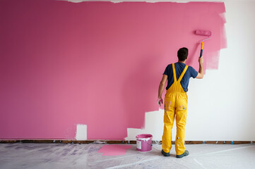 The painter is painting the brush on the wall of the room.