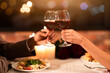 © Prostock-studio - Celebrating Valentine's Day. Unrecognizable Couple In Love Clinking Glasses Drinking Wine On Romantic Date In Restaurant. Cropped
