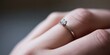 © gunzexx png and bg - A close-up view shows a person's hand adorned with a simple, elegant solitaire engagement ring, signifying commitment and love in a timeless jewelry design.