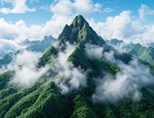 Wall Mural - Majestic mountain peak surrounded by lush green forests and clouds