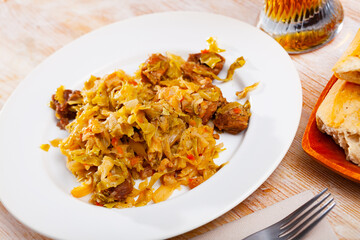 Wall Mural - Portion of stewed cabbage with pork, healthy dinner