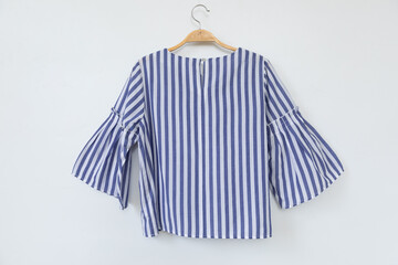 Sticker - blue blouse is clothes hanger on white background.