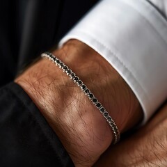 Close up of a man's hand wearing a black bracelet with diamonds