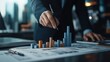 © Phirakhup - A business professional analyzing data charts with bar graphs, symbolizing market trends and financial strategies.