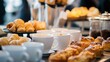 © somchai20162516 - A close-up of a coffee break setup at a conference, with cups, pastries, and networking professionals
