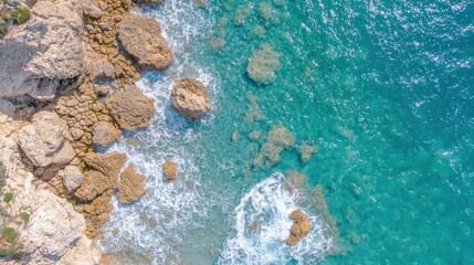 Aerial View of Rocky Coastline with Turquoise Water and Waves